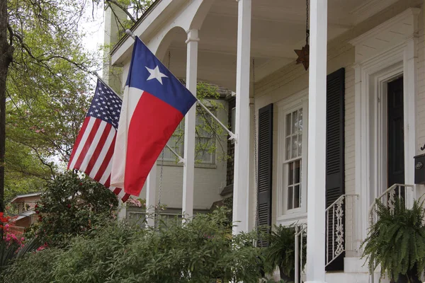 Historic Home With Texas and American Flags Springtime