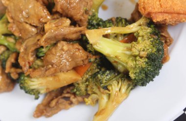Beef Broccoli and Egg Roll on Plate at Chinese Restaurant