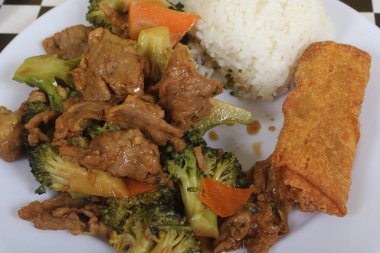 Beef Broccoli and Egg Roll on Plate at Chinese Restaurant