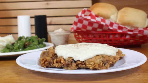Chicken Fried Steak and Gravy With Mashed Potatoes in Rural Cafe