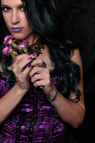 Woman in Purple Corset With Green and Black hair and Purple Flowers