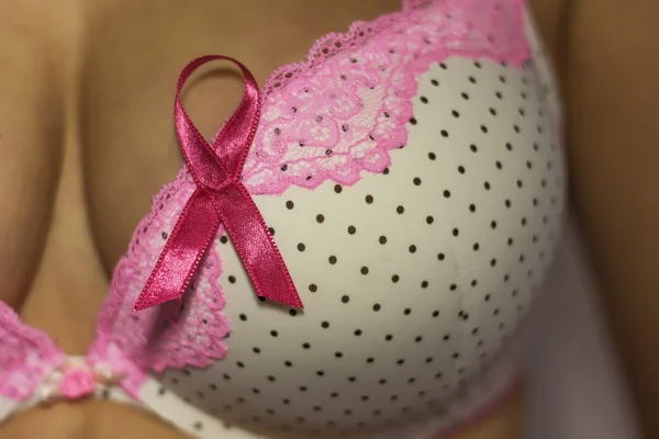 Woman in bra with pink ribbon — Stock Photo, Image