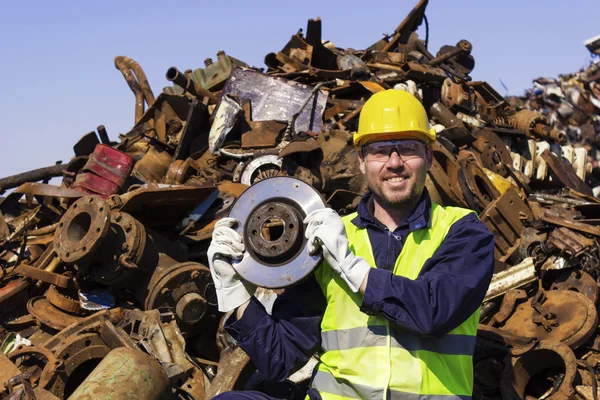 Worker on junkyard hold rotor like shiny trophy — Stock Photo, Image