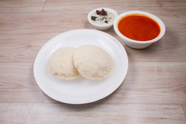 Indian rice cake with lentil curry. South Indian breakfast. Idali sambar