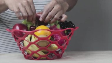 Evde meyve sepeti düzenleyen bir adam var. arkaplan kayıtları.
