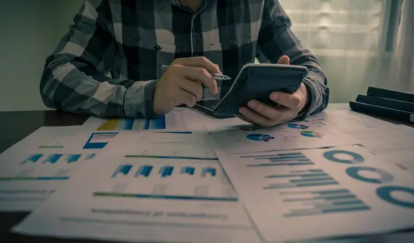 Hesap makinesi tutan ve istatistik, vergi, gelir, kayıp, kazanç hesaplayan muhasebeci ya da işadamı. İstatistikler ve analitik araştırma konsepti. Sancak kopyalama alanı.