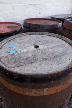 Bir grup eski viski fıçısı hava şartları için dışarıda bırakılmış, siyah ve beyaz..