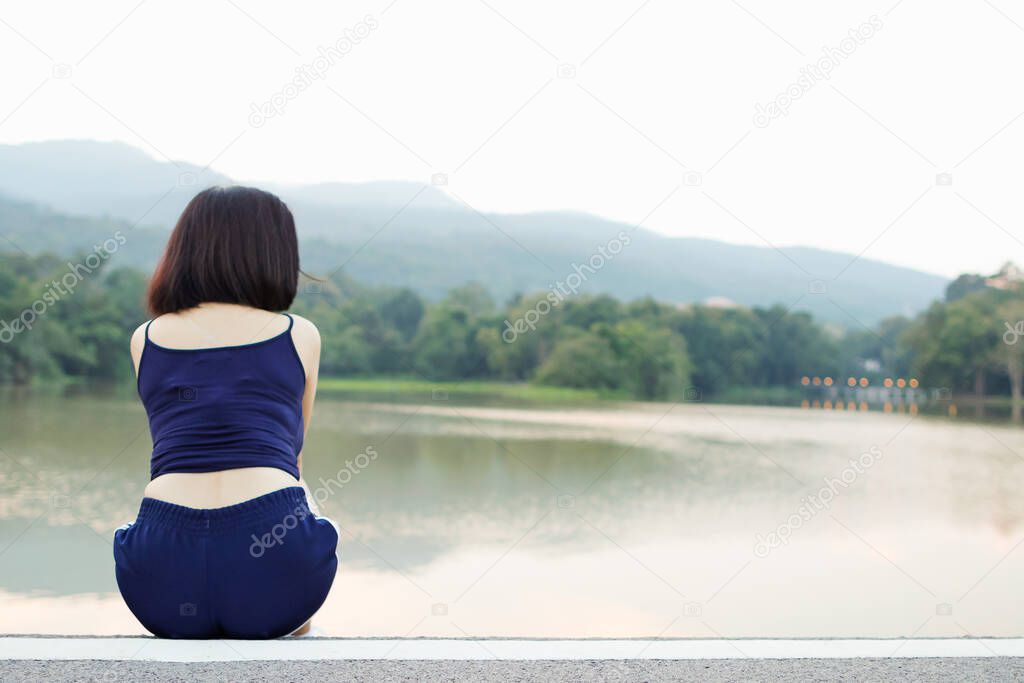 A young woman who feels lonely and sad alone on the edge of a water tower in the morning because of problems with her lover. The concept of loneliness and lonely from the problem of love.