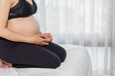 The expectant mother put her hands on her belly lovingly because she felt the force of the baby in the womb, and she prayed to God with her faith and power to deliver the baby and she is safe