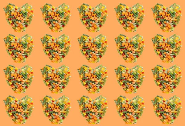 Heart Shaped Frozen Vegetable Mix Pattern Shadow Orange Background Concept — Stock Photo, Image