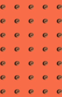 A pattern of roasted coffee beans on a brown background. Grocery pattern. Templates, prints.