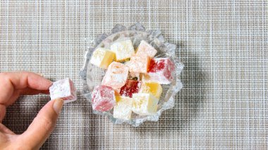 Yavaş yavaş şeffaf bir bardakla doldurulan Türk lokumu. Türk tatlısı. Üst görünüm.