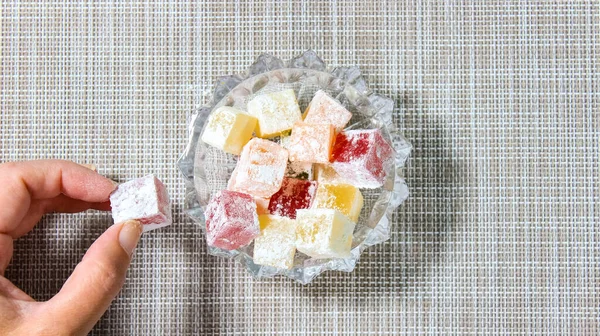 Yavaş yavaş şeffaf bir bardakla doldurulan Türk lokumu. Türk tatlısı. Üst görünüm.