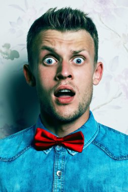 Shocked face concept. Fashion portrait of a surprised hipster yo clipart