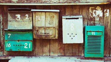 Old memory mailboxes concept. Multicolored old shabby mailboxes  clipart