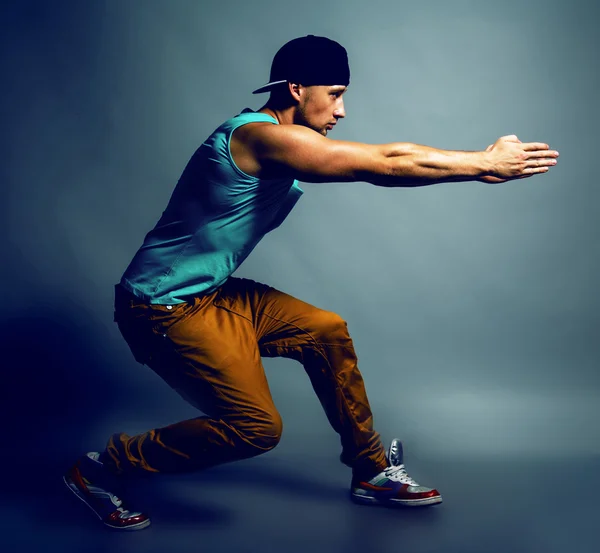 Young handsome male hip-hop dancer in trendy clothing showing so — Stock Photo, Image
