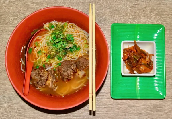 Top view of Sour and spicy small round noodle soup recipe with beef meat curry.