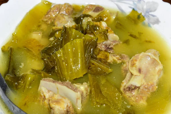 Sour white mustard soup with pork ribs recipe. Cooked in Asia, Myanmar. Closeup view