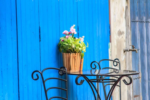 Vintage home arrangement, summer flowers and enamelware on wall