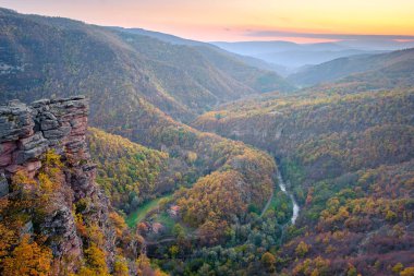 Amazing view from Tumba vantage point on a canyon with meandering river Temstica, autumn colored trees and a rocky summit clipart