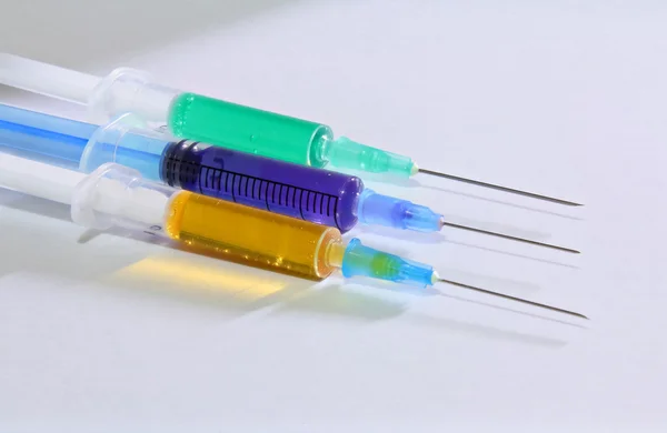 Three syringes on the white background — Stock Photo, Image