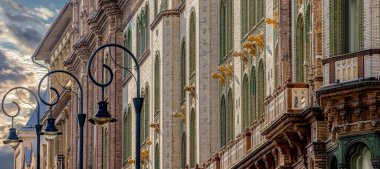 Art Nouveau tarzı Brudern House 'un ayrıntıları (ayrıca Paris Avlusu olarak da bilinir). Erkek ve kadın figürlerinin Majolica heykelleri Macaristan 'ın başkenti Budapeşte' de öğleden sonra geç saatlerde sokağa bakıyorlar.