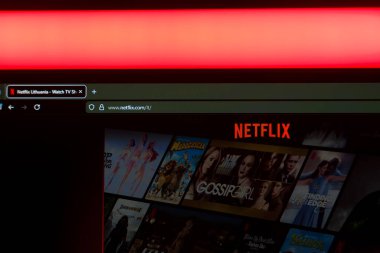 Çevrimiçi video eğlencesini temsil eden canlı kırmızı ışıklandırma ile resmi kırmızı logoyu içeren bir bilgisayar ekranındaki Netflix yayın servis arayüzünü kapatın. Yüksek kalite fotoğraf