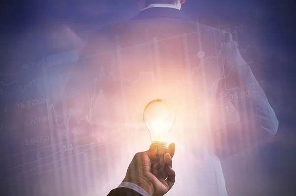 Businessman holding light bulb on stock market investment tradingl — Stock Photo, Image