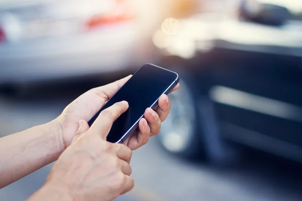 Woman using smartphone at roadside after car accident — Stock Photo, Image