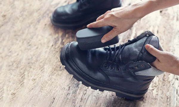 Sapatos de limpeza em fundo de madeira — Fotografia de Stock