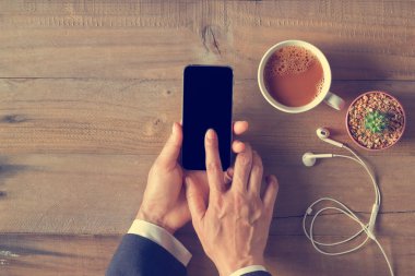 El telefon siyah perde ahşap arka plan üzerinde üstten görünüm kullanma