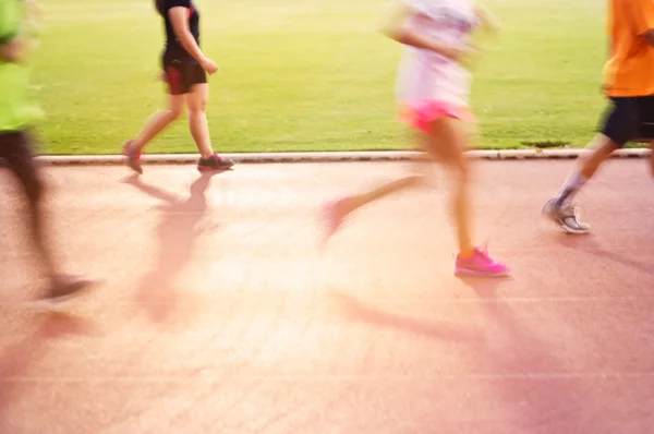 Blurred colorful people jogging on the racetrack, soft and blur — Stock Photo, Image