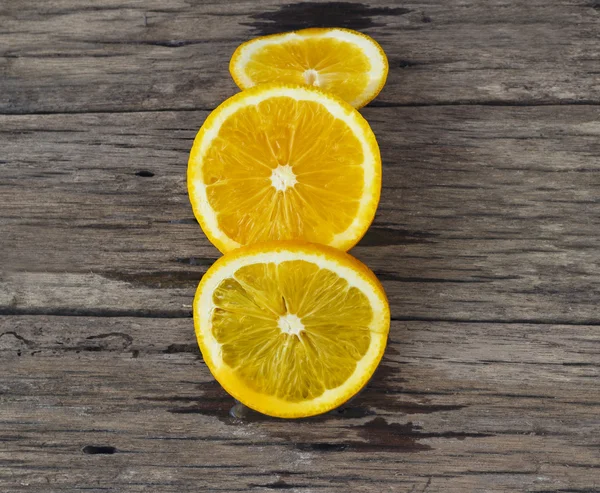 Laranja cortada na mesa de madeira — Fotografia de Stock