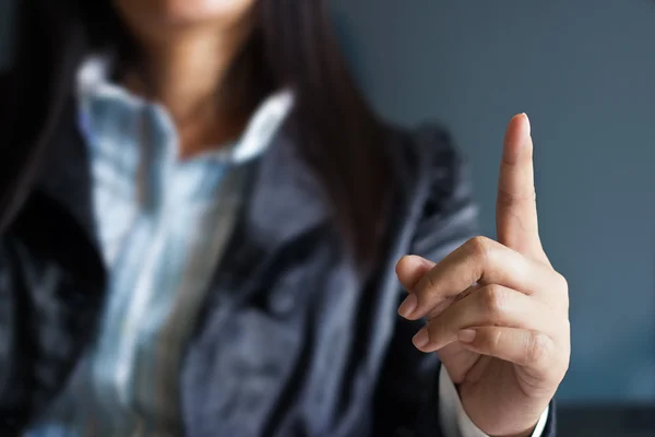 Liiketoiminnan nainen osoittaa ylös sormella — kuvapankkivalokuva