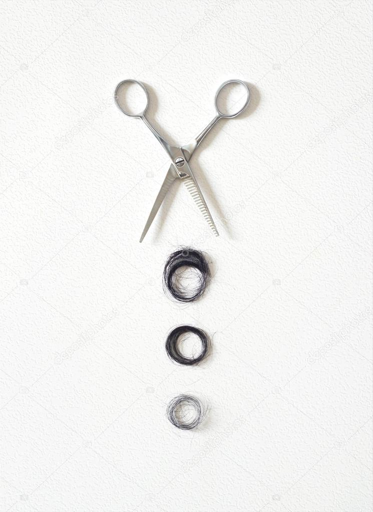 Hair asian cut off scissors on white wall background