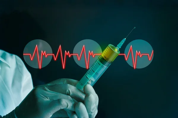 Syringe in hand glove of a Cardiac Frequency on blue lab medical — Stock Photo, Image