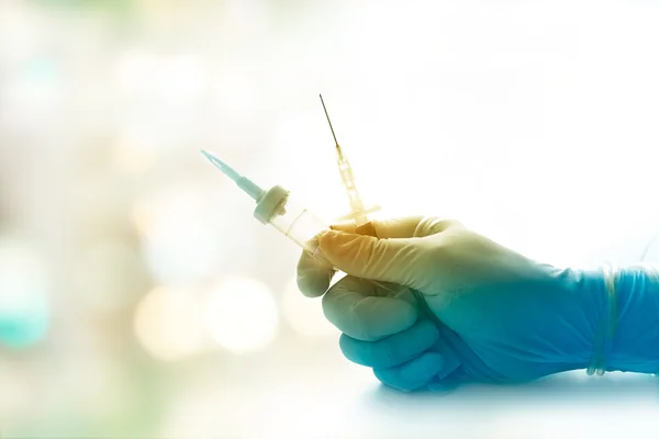 Colorful sterile syring and doctor use medical gloves to inject patient — Stock Photo, Image