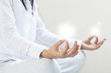 woman meditating of purity energy insight on gray background clipart