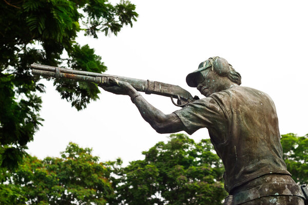 bronze public sculpture of shoot gun athlete