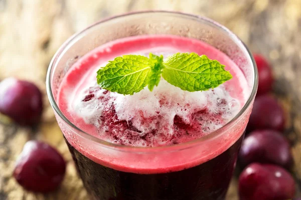 Vibrant smoothie cherry on wooden background — Stock Photo, Image