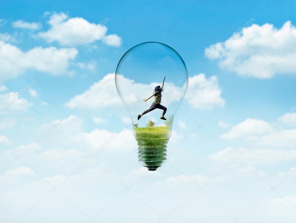 Abstract women jump on green nature in bulb light with blue sky