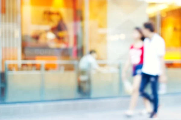 Verschwommene bunte Coffee-Shop und Menschen gehen auf der Straße im Freien — Stockfoto