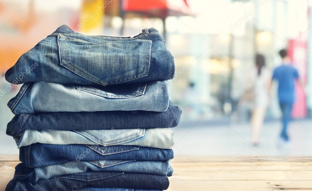 jeans in shop on wooden and shopping store background