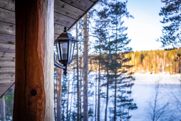 Lantern of wooden house in winter forest