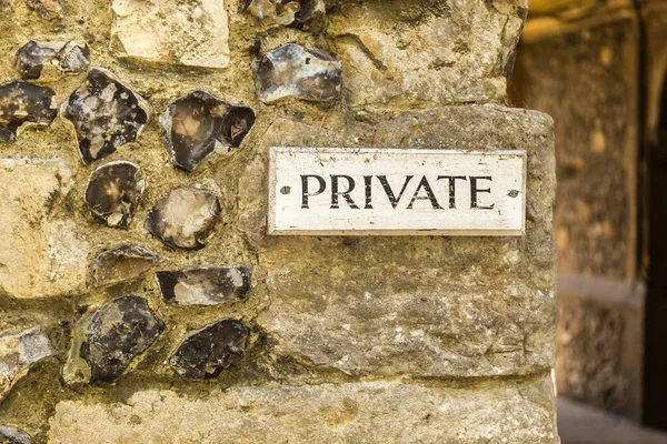 Private sign on stone wall, England