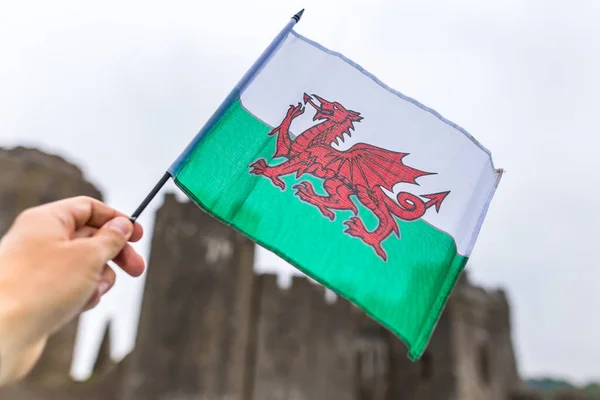 Waiving Welsh flag with red dragon in Pemborke castle, Wales