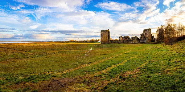 Aerial view of ruins of Flint castle in Flintshire, Wales, lying on the estuary of the River Dee, UK