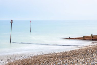 A view of the high tide and tidal poles at the seaside, Worthing, UK