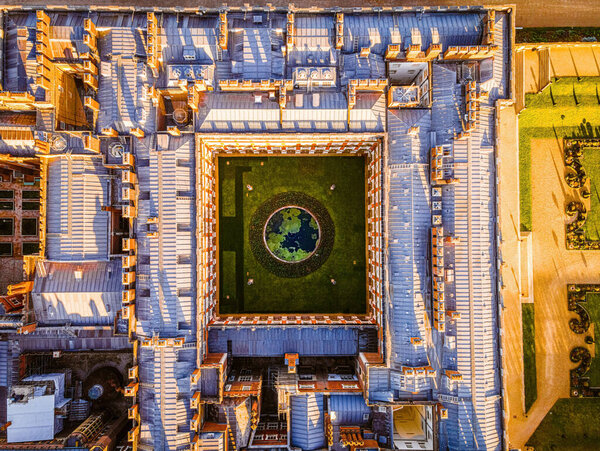 The aerial view of Hampton Court Palace, a royal palace in the London Borough of Richmond upon Thames, UK