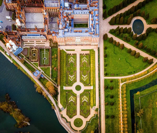 The aerial view of Hampton Court Palace, a royal palace in the London Borough of Richmond upon Thames, UK